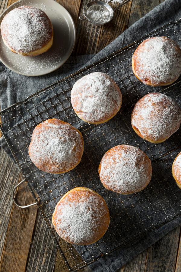 Paczki, hand-filled and dusted with powdered sugar. (Shutterstock)