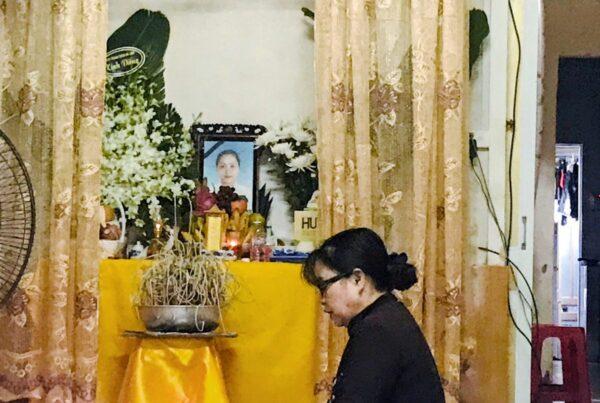 A woman prays at an altar with an image of Pham Thi Tra My, a victim of 39 deaths in a truck container in UK, at her home in Ha Tinh province, Vietnam on Oct. 27, 2019. (Kham/Reuters)