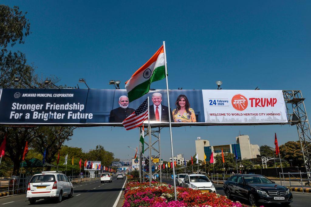 U.S. and Indian national flags wave in front of a billboard displaying pictures of India's Prime Minister Narendra Modi (L) and U.S. President Donald Trump (C) and his wife Melania (R) near the Sardar Vallabhbhai Patel International Airport in Ahmedabad on Feb. 22, 2020, ahead of U.S. President Donald Trump's visit in India. (Sam Panthaky/AFP via Getty Images)