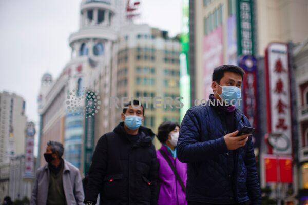 People wear masks at a main shopping area as the country is hit by an outbreak of the new coronavirus in downtown Shanghai, China, on Feb. 21, 2020. (Aly Song/Reuters)