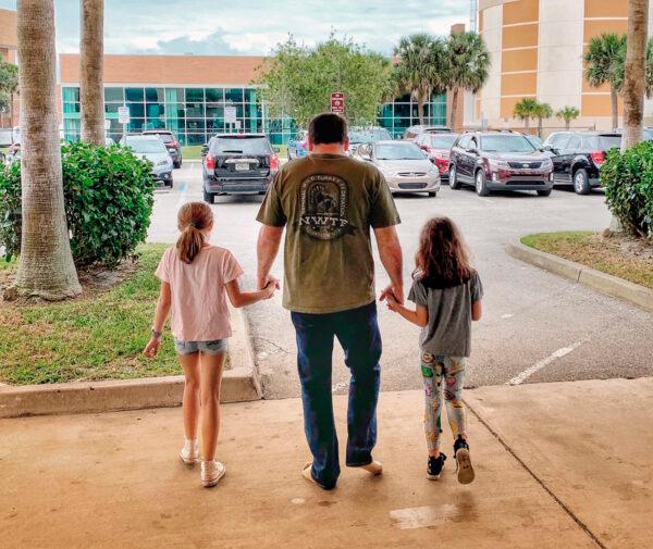NASCAR driver Ryan Newman and his daughters, Brooklyn Sage (L) and Ashlyn Olivia, leave Halifax Medical Center in Daytona Beach, Fla., on Feb. 19, 2020. (Roush Racing via AP)