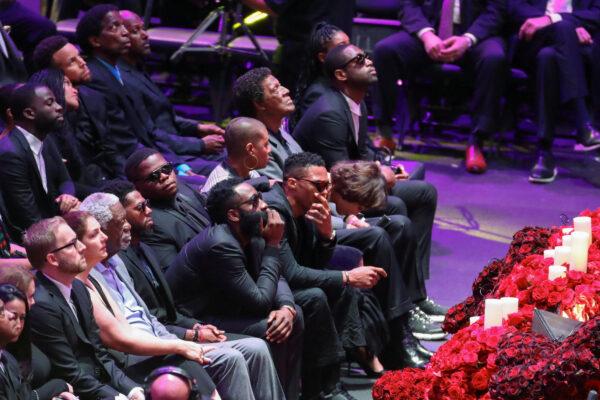 Basketball players Draymond Green and Steph Curry, former basketball player Bill Rusell, basketball players James Harden, Russell Westbrook, and former basketball player Dwyane Wade attend a public memorial for NBA great Kobe Bryant, his daughter Gianna and seven others killed in a helicopter crash on Jan. 26, at the Staples Center in Los Angeles, Calif., on Feb. 24, 2020. (Lucy Nicholson/Reuters)