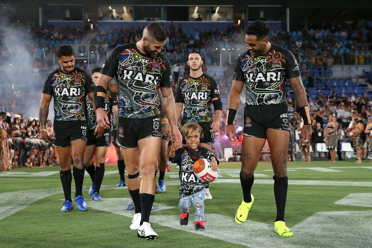 Quaden walking with the Indigenous All-Stars at Cbus Super Stadium on Feb. 22, 2020 (©Getty Images | <a href="https://www.gettyimages.com/detail/news-photo/quaden-bayles-runs-onto-the-field-before-the-nrl-match-news-photo/1207917671?adppopup=true">Jason McCawley</a>)