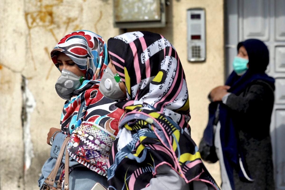 People wear masks to help guard against the new coronavirus in downtown Tehran, Iran on Feb. 23, 2020. (Ebrahim Noroozi/AP Photo)