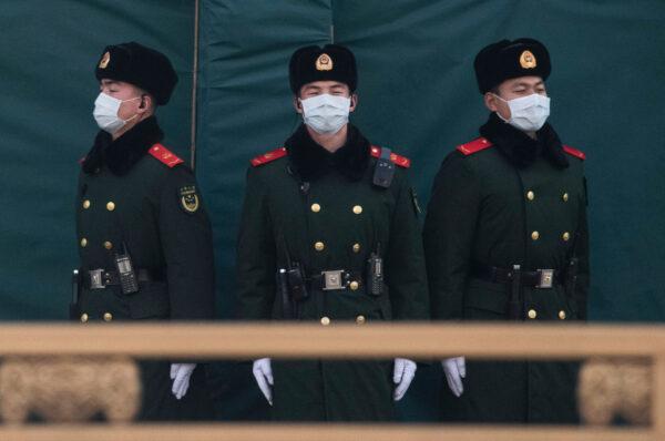 Chinese police wear protective masks as they stand guard on a main road in Beijing, China, on Jan. 31, 2020. (Kevin Frayer/Getty Images)