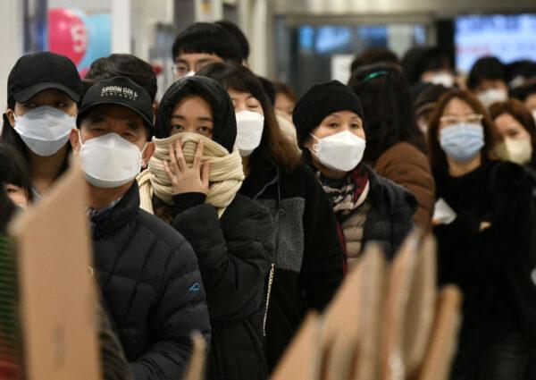 People wait in line to buy face masks at a retail store in Daegu, South Korea, on Feb. 25, 2020. (Jung Yeon-je/AFP via Getty Images)