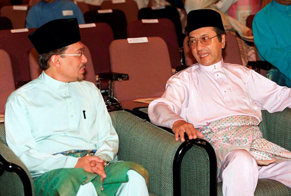 Malaysia's Prime Minister Mahathir Mohamad (R) chats with deputy premier Anwar Ibrahim, who is also the finance minister, in Kuala Lumpur on May 11, 1997. (Stringer/Reuters File)