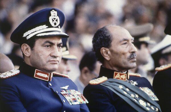 Egyptian President Anwar Sadat (R) and Vice President Hosni Mubarak sit on the reviewing stand during a military parade just before soldiers opened fire from a truck during the parade at the reviewing stand, killing Sadat and injuring Mubarak, on Oct. 6, 1981. (Bill Foley/AP Photo)
