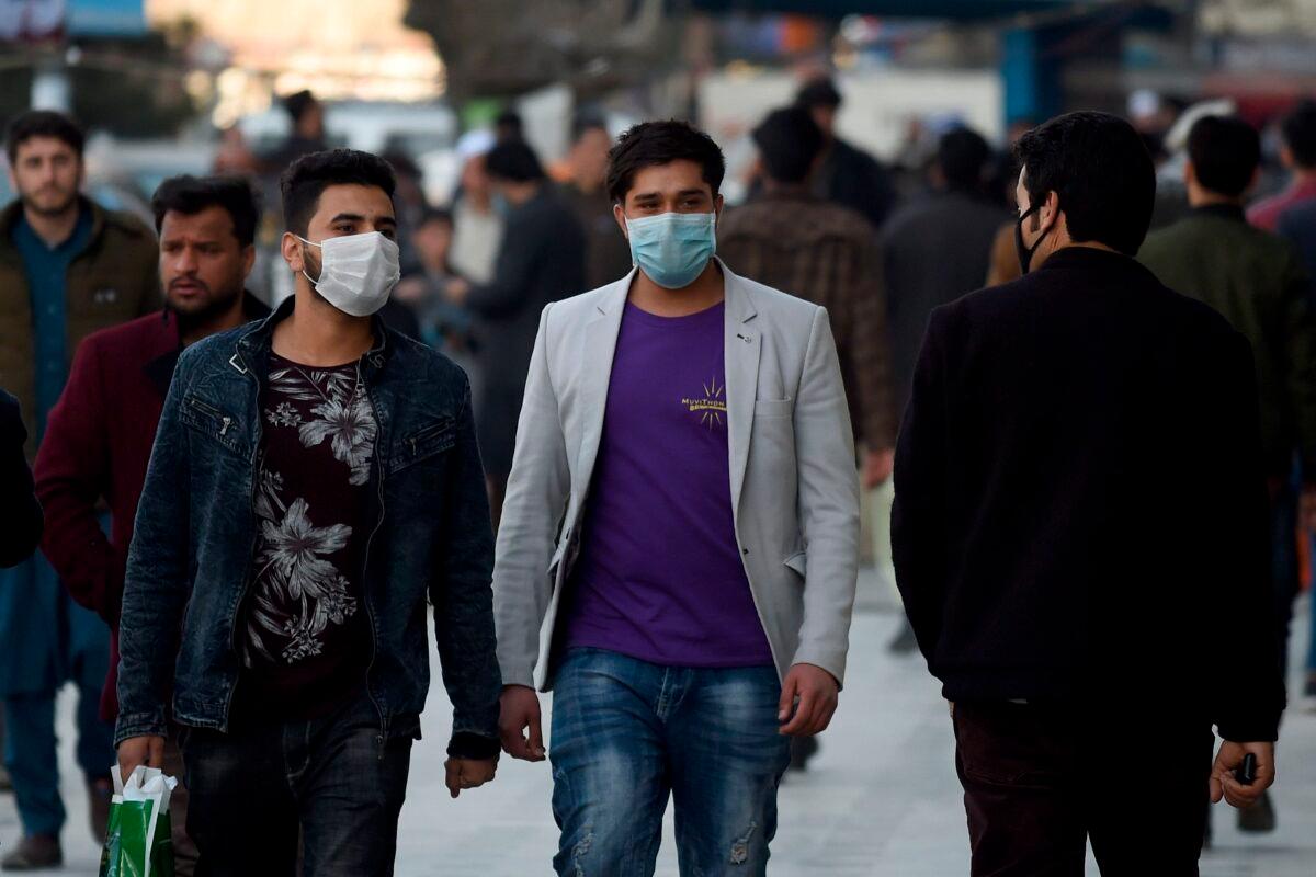Men wearing protective face masks walk at the Shahr-i-Naw area in Kabul, Afghanistan, on Feb. 5, 2020. (Wakil Kohsar/AFP via Getty Images)