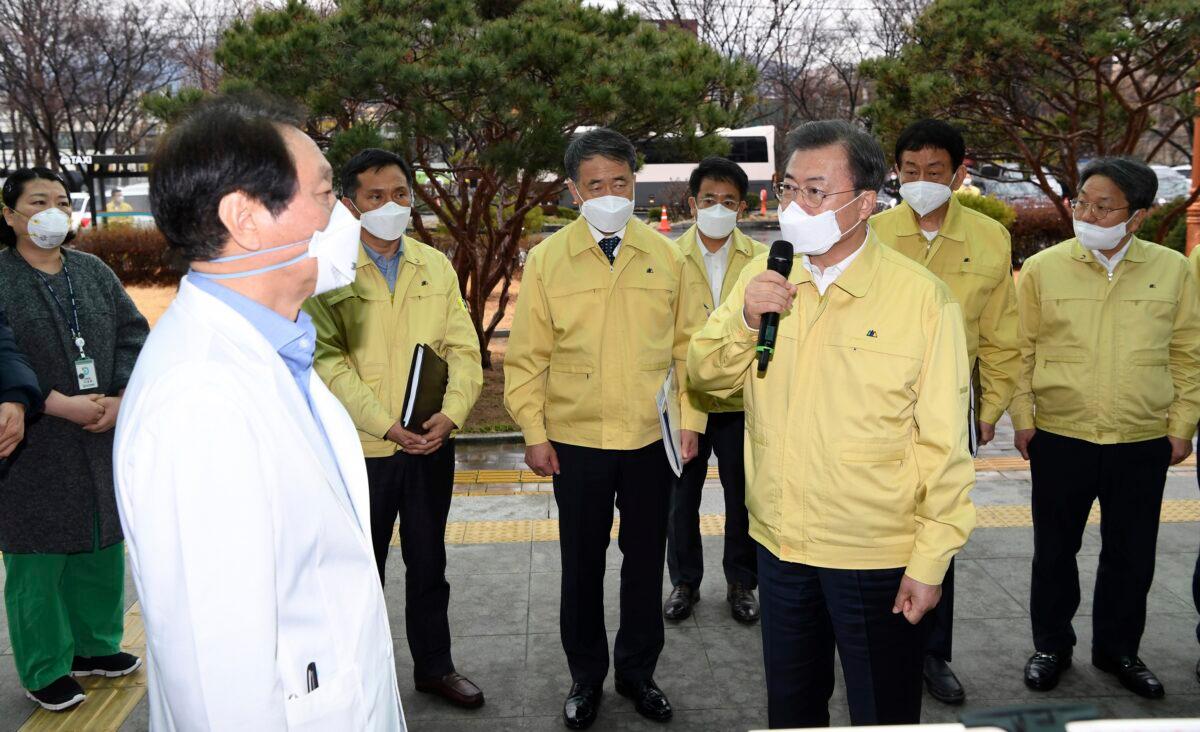 South Korean President Moon Jae-in, front right, talks to a president of Daegu Medical Center, You Wansik, at the Daegu Medical Center in Daegu, South Korea, on Feb. 25, 2020. (Bae Hun-shik/Newsis via AP)