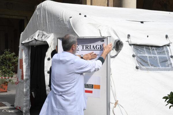 A medical staff member sets up a pre-triage medical tent in front of Santa Maria Nuova Hospital in Florence, Italy, on Feb. 25, 2020. (Carlo Bressan/AFP via Getty Images)