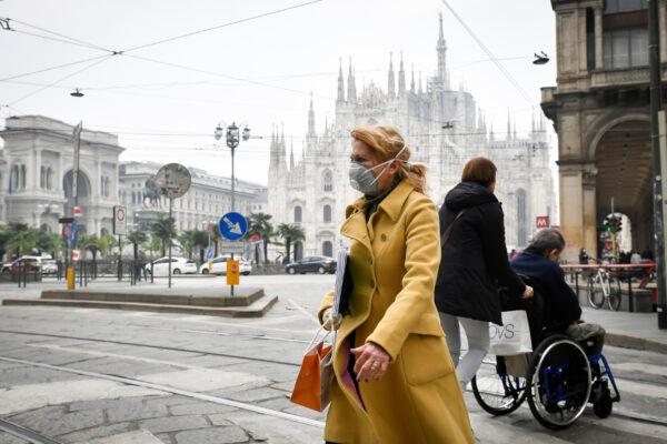 A woman wears a sanitary mask in downtown Milan, Italy, on Feb. 25, 2020. (Claudio Furlan/Lapresse via AP)