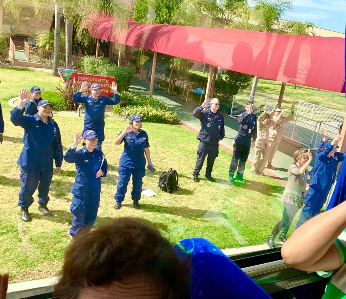 Working staff are waving their hands to the leaving quarantined passengers who were free of the coronavirus at the quarantine center that is located at Marine Corps Air Station in Miramar, California, on Feb. 18, 2020. (Provided to The Epoch Times by David)