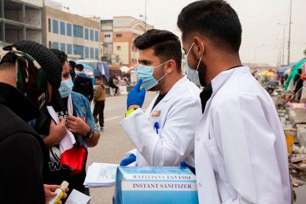 Iraqi students distribute leaflets about coronavirus prevention in the southern Iraqi city of Basra on Feb. 25, 2020. (Hussein Faleh/AFP via Getty Images)