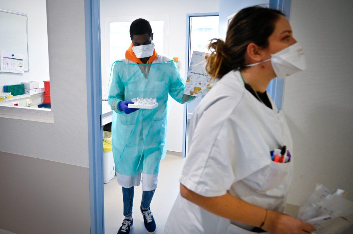 Medical staff from the IHU (Institut Hospitalo-Universitaire) Mediterranee Infection Institute work in the laboratory to analyze samples on the possible presence of the COVID-19 in Marseille, France, on Feb. 26, 2020. (Gerard Julien/AFP via Getty Images)