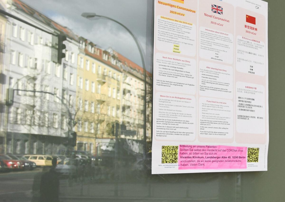 A poster with information about the new coronavirus and an advice on how to get medical help for suspected symptoms is displayed at an entry door of a doctor's office in Berlin, Germany on Feb. 25, 2020. (Annegret Hilse/Reuters)