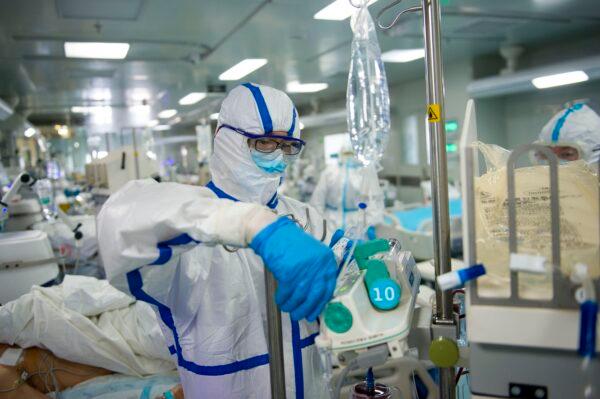A nurse is operating a piece of equipment in an intensive care unit treating COVID-19 coronavirus patients at a hospital in Wuhan, China, on Feb. 22, 2020. (STR/AFP via Getty Images)