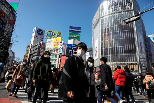 People wearing protective masks are seen in the Shibuya shopping district in Tokyo, Japan on Feb. 24, 2020. (Athit Perawongmetha/Reuters)