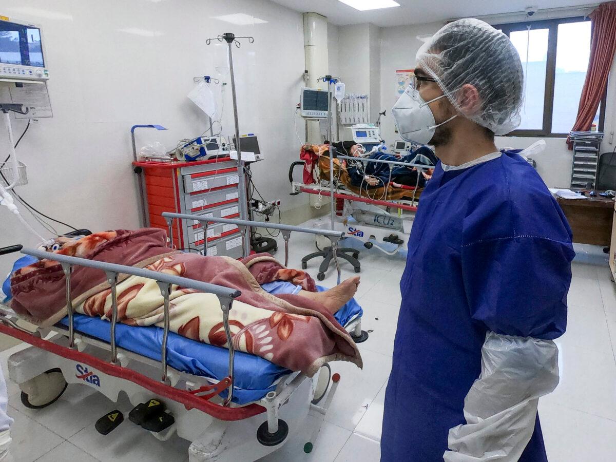A nurse cares for patients in a ward dedicated for people infected with the coronavirus, at Forqani Hospital in Qom, 78 miles (125 kilometers) south of the capital Tehran, Iran on Feb. 26, 2020. (Mohammad Mohsenzadeh/Mizan News Agency via AP)