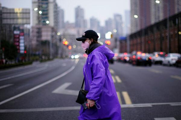 A woman wearing a face mask is seen on a street in downtown Shanghai, China, as the country is hit by an outbreak of a new coronavirus, on Feb. 26, 2020. (Aly Song/Reuters)