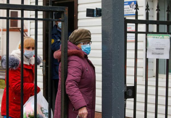 People walk through a gate of a hospital for infectious diseases, after Belarus registered the first case of coronavirus infection in the country, in Minsk, Belarus on Feb. 28, 2020. (Vasily Fedosenko/Reuters)