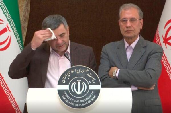 The head of Iran's counter-coronavirus task force Iraj Harirchi (L) wipes his face during a press briefing with government spokesman Ali Rabiei, in Tehran, Iran, on Feb. 24, 2020. (APTN via AP)