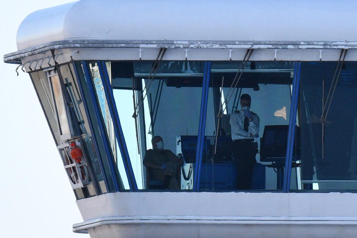 Crew members aboard the Diamond Princess cruise ship are seen at its wheelhouse at the Daikoku Pier Cruise Terminal in Yokohama port on Feb 27, 2020. (Kazuhiro Nogi/AFP via Getty Images)