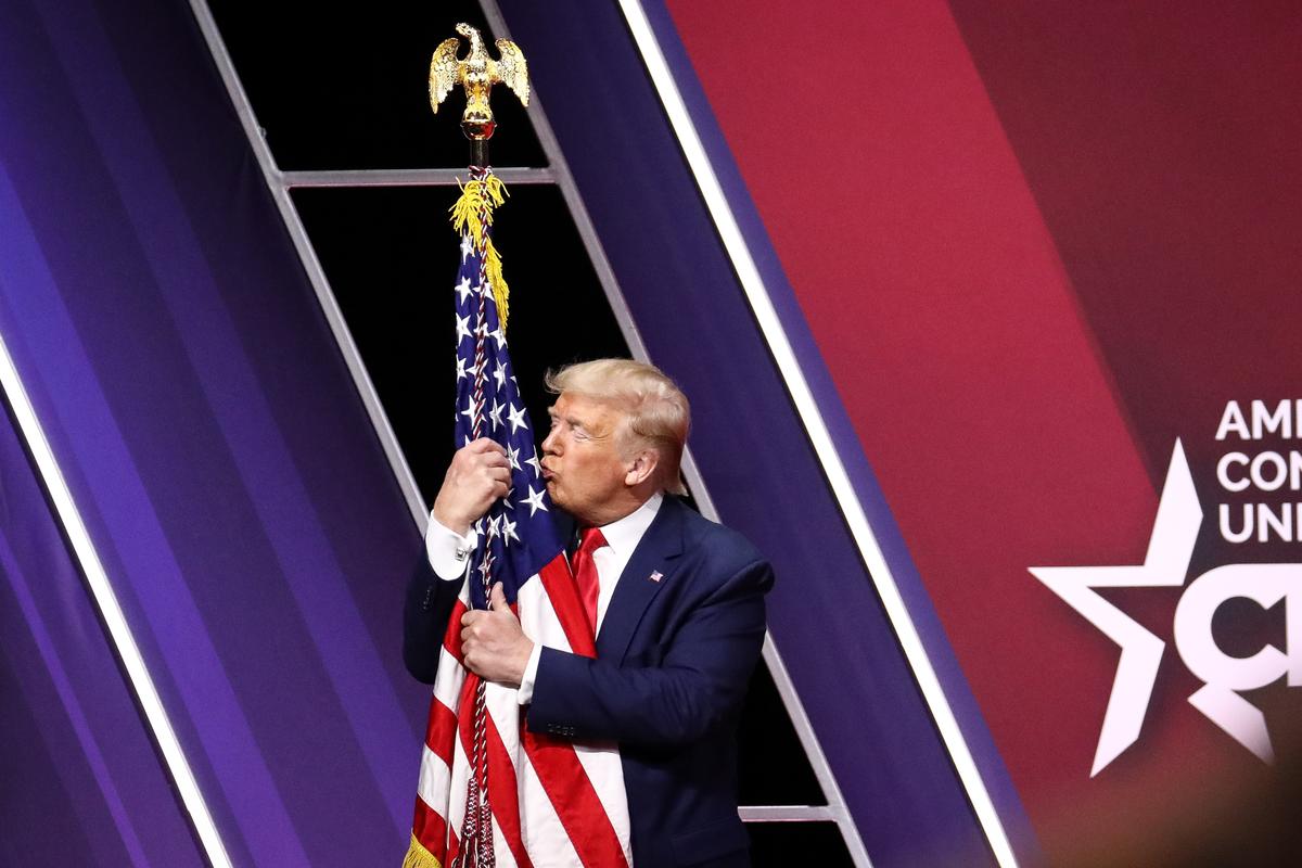 President Donald Trump kisses the American flag after speaking at the CPAC convention in National Harbor, Md., on Feb. 29, 2020. (Samira Bouaou/The Epoch Times)