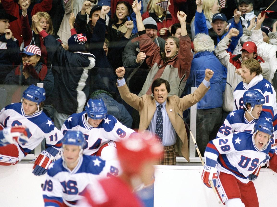 Herb Brooks (Kurt Russell, C) celebrates victory among his players, in “Miracle.” (Chris Large/Buena Vista Pictures Distribution/Disney)