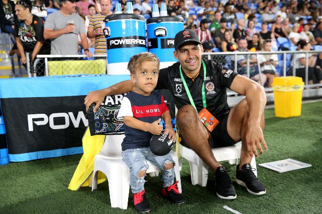 Rugby fiend Quaden Bayles alongside professional rugby player Cody Walker. Bayles made a special appearance in his honor before the NRL match between the Indigenous All-Stars and the New Zealand Maori Kiwis All-Stars at Cbus Super Stadium, Gold Coast, Australia on Feb. 22, 2020. (Jason McCawley/Getty Images)