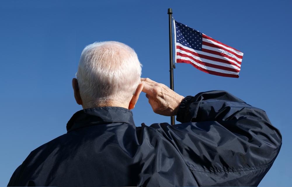 Illustration - Shutterstock | <a href="https://www.shutterstock.com/image-photo/view-veteran-saluting-flag-united-states-772898548">Stockagogo Photos</a>