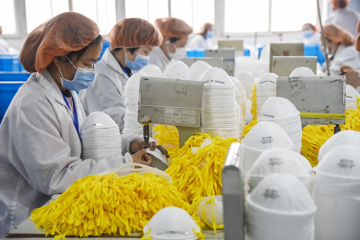 Workers produce masks at a factory in Handan, China, on Feb. 28, 2020. (AFP via Getty Images)