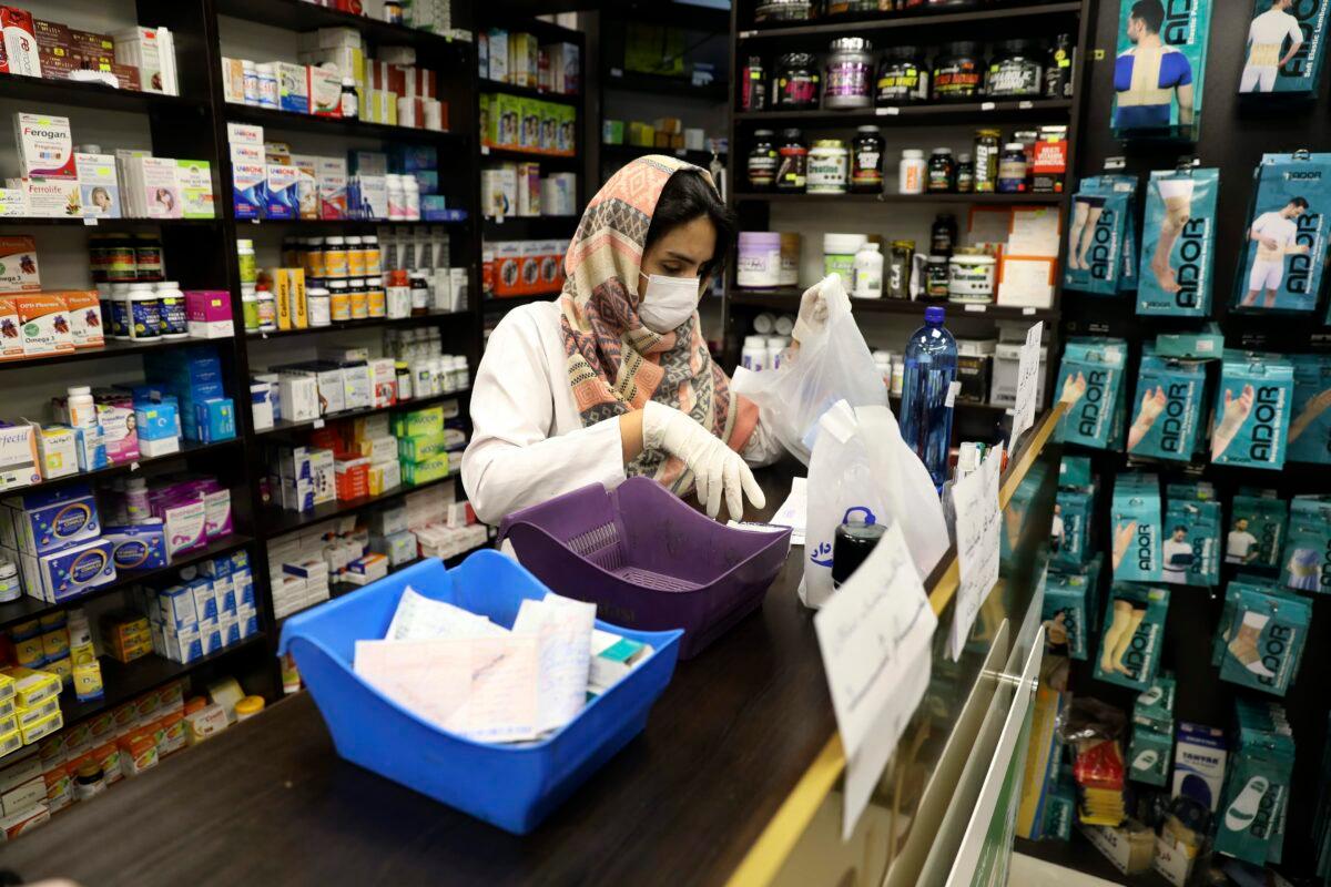 A pharmacist wearing a face mask works in western Tehran, Iran, on Feb. 29, 2020. (Vahid Salemi/AP Photo)