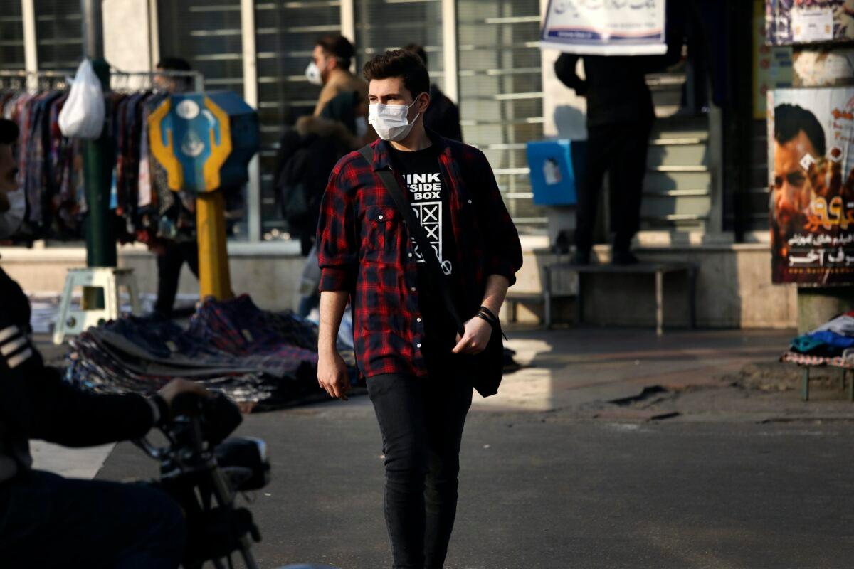 A pedestrian wearing a face mask crosses a street in western Tehran, Iran, on Feb. 29, 2020. (Vahid Salemi/AP Photo)