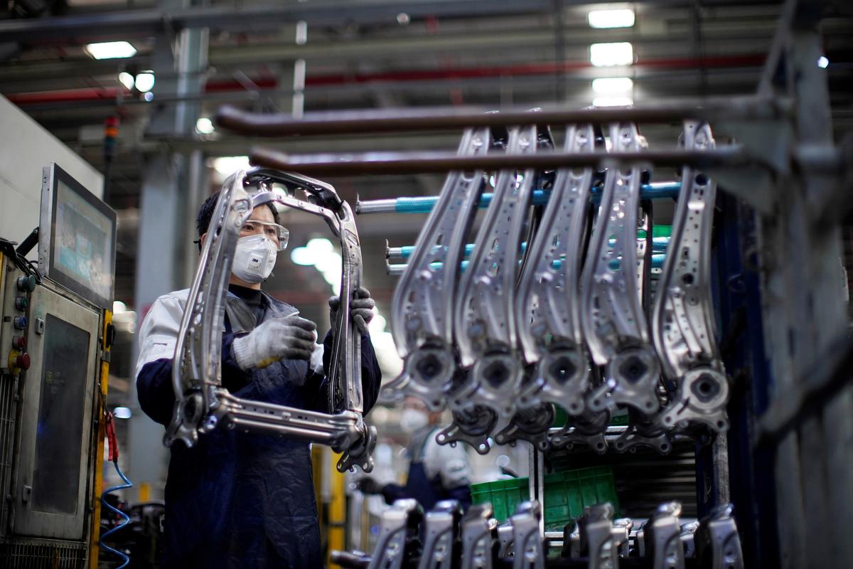 An employee wearing a face mask works on a car seat assembly line at Yanfeng Adient factory in Shanghai, China, as the country is hit by an outbreak of a new coronavirus, on Feb. 24, 2020. (Aly Song/Reuters)