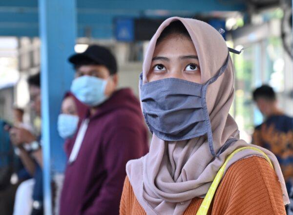 A woman wearing a face mask stands on a street in Jakarta on March 2, 2020. (Adek Berry/AFP/Getty Images)
