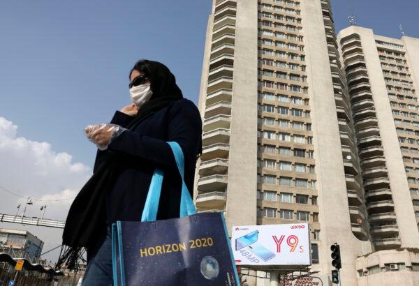 A pedestrian wearing a face mask crosses a street in northern Tehran, Iran on March 1, 2020. (Vahid Salemi/AP Photo)