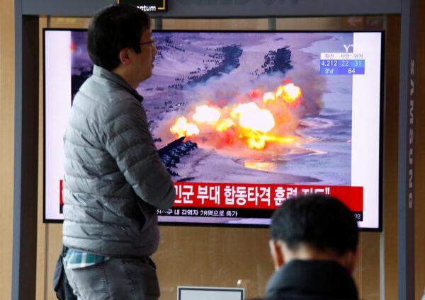A man walks past a TV showing a file picture for a news report on North Korea firing two unidentified projectiles, in Seoul, South Korea on March 2, 2020. (Heo Ran/Reuters)