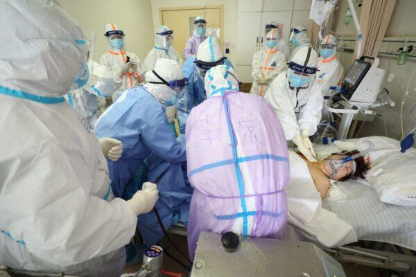 A patient infected by the CCP virus is receiving treatment by extracorporeal membrane oxygenation (ECMO) at the Red Cross hospital in Wuhan, China, on Feb. 28, 2020. (STR/AFP via Getty Images)