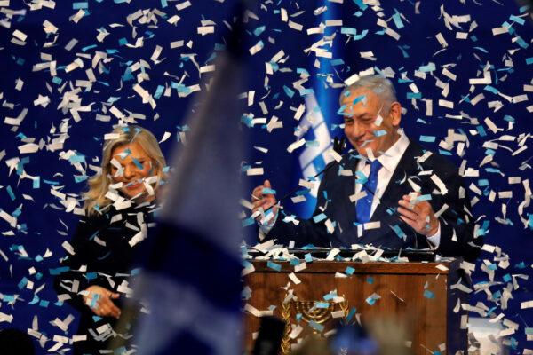 Confetti falls as Israeli Prime Minister Benjamin Netanyahu stands next to his wife Sara after speaking to supporters following the announcement of exit polls in Israel's election at his Likud party headquarters in Tel Aviv, Israel, on March 3, 2020. (Amir Cohen/Reuters)