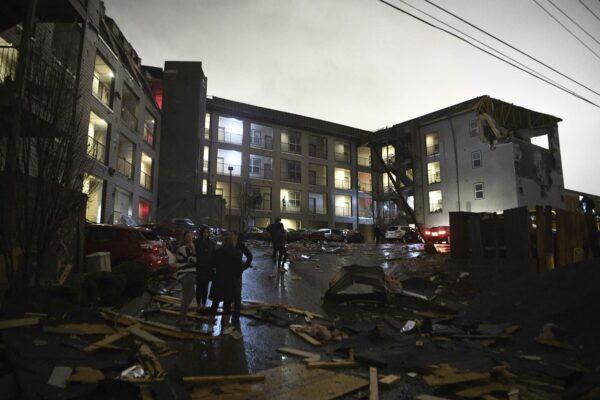 Debris is scattered across the parking lot of a damaged apartment building after a tornado hit Nashville in the early morning hours of March 3, 2020. (Courtney Pedroza/The Tennessean via AP)