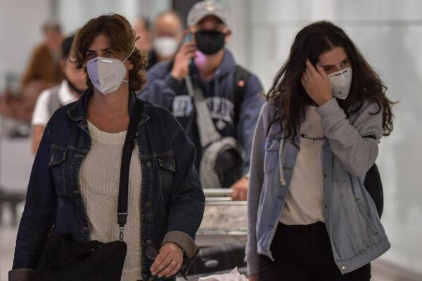 Passengers wearing masks arrive on a flight from Italy at Guarulhos International Airport, in Guarulhos, Sao Paulo, Brazil, on March 2, 2020. (Nelson Almeida/AFP via Getty Images)