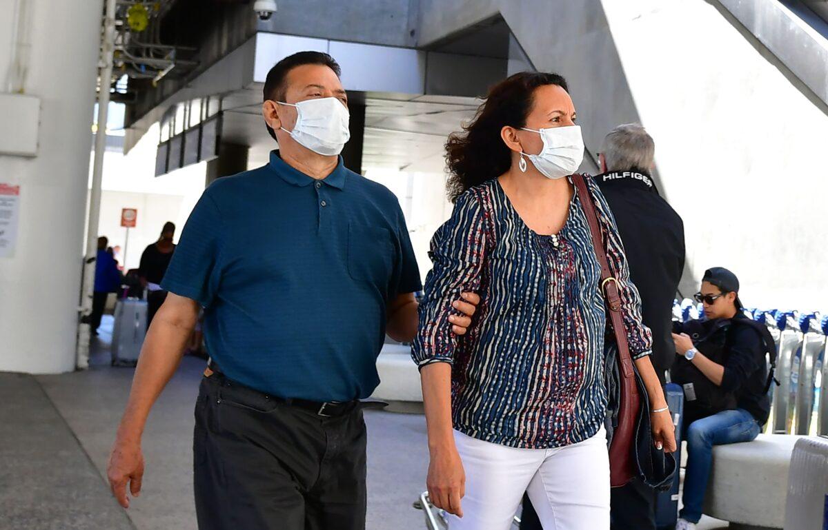 People wear face masks at Los Angeles International Airport in Los Angeles, California, on March 2, 2020. (Frederic J. Brown/AFP via Getty Images)