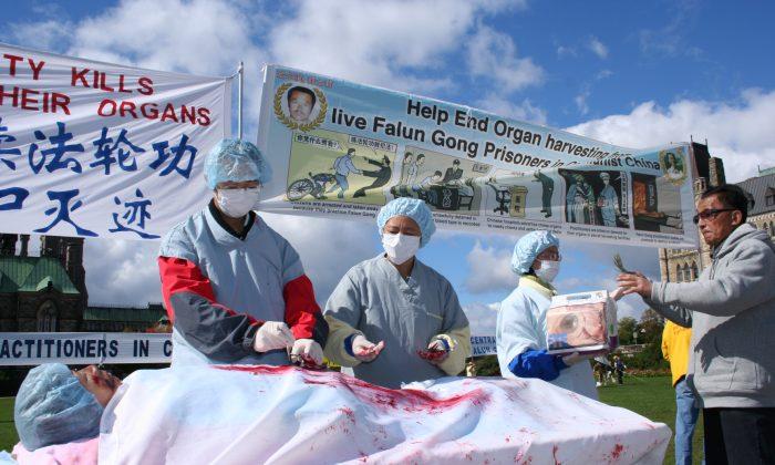 A reenactment of organ harvesting in China on Falun Gong practitioners, during a rally in Ottawa, Canada, 2008. (The Epoch Times)