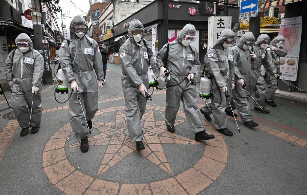 South Korean soldiers wearing protective gear spray disinfectant to help prevent the spread of the novel coronavirus, at a shopping district in Seoul on March 4, 2020. (Jung Yeon-je/AFP via Getty Images)