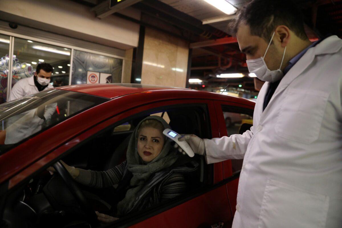 A woman has her temperature checked as she enters the Palladium Shopping Center, in northern Tehran, Iran, on March 3, 2020. (Vahid Salemi/AP Photo)
