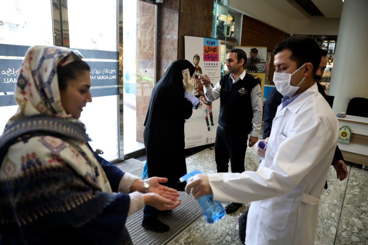 People have their temperature checked and their hands disinfected as they enter the Palladium Shopping Center, in northern Tehran, Iran, Tuesday, March 3, 2020. (Vahid Salemi/AP Photo)