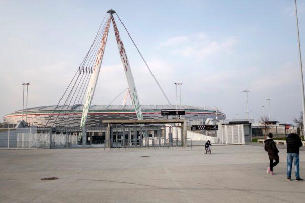 A child rides his bicycle outside a closed Allianz Stadium in Turin, northern Italy, on March 1, 2020. (Marco Alpozzi/LaPresse via AP)