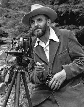 Photographic portrait of nature photographer Ansel Adams, which first appeared in the 1950 Yosemite Field School yearbook. (Public Domain)
