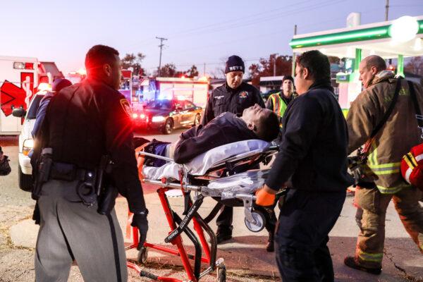 A man overdosing in a gas station parking lot is helped by emergency personnel in the Harrison Township of Dayton, Ohio, on Nov. 1, 2019. (Charlotte Cuthbertson/The Epoch Times)